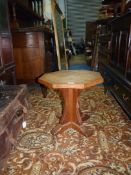 A Mouseman octagonal Oak occasional Table standing on a cross design support featuring the