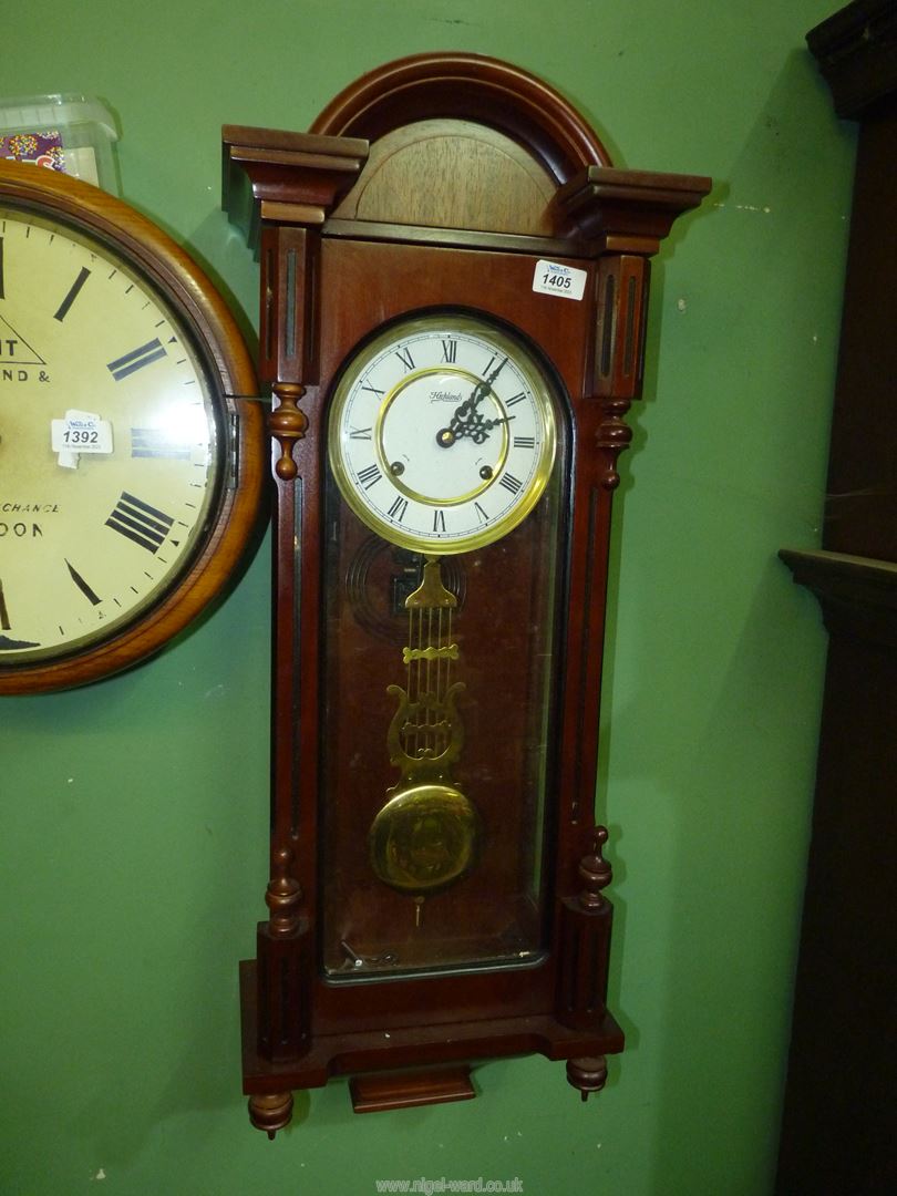 A Vienna type Wall Clock by Highlands having a two train spring driven movement striking on a gong,