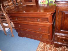 A contemporary satinwood finished Chest of three long Drawers and having canted corners,