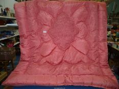 A single pink Eiderdown with ruched and emboidered pattern ,some marks.