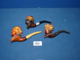 Three antique Meerschaum pipes, all exquisitely carved with ladies heads.