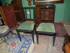 A pair of arts and crafts ebonised finish Side Chairs having tapering bobbin turned components and