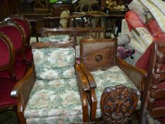 A low dark-wood framed Bergere type three piece lounge suite having caned sides and backs and