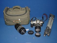A Canon EOS 500 35 mm SLR camera with accessories and tripod.