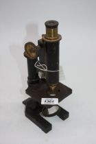 A vintage brass Microscope having an object lens engraved "R & J Beck, Poly",