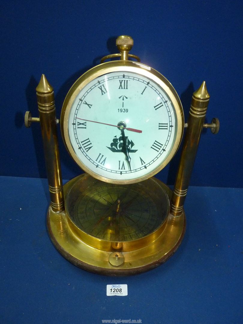 A heavy Brass Mantle Clock with compass in the base and the dial having ship detail and the date