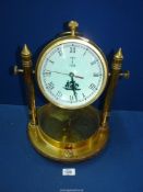 A heavy Brass Mantle Clock with compass in the base and the dial having ship detail and the date