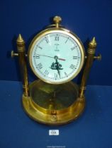 A heavy Brass Mantle Clock with compass in the base and the dial having ship detail and the date