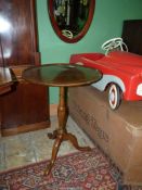 A compact snap top Mahogany occasional table standing on a turned pillar with splay feet,