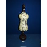 A miniature butterfly decorated decoupage Mannequin on dark wood turned base with baize under,