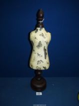 A miniature butterfly decorated decoupage Mannequin on dark wood turned base with baize under,