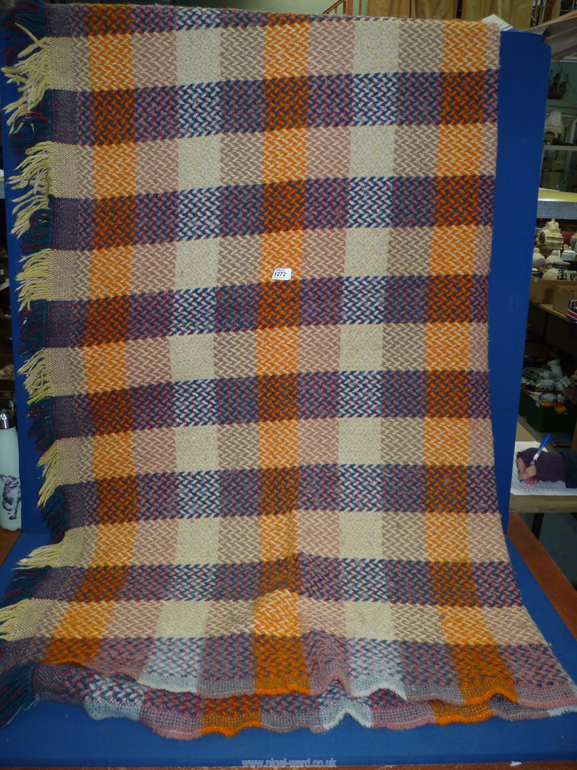 A patchwork and herringbone effect fringed blanket.