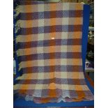 A patchwork and herringbone effect fringed blanket.