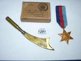 A WWII 1939 - 1945 Military Star medal and a Trench Art letter opener.