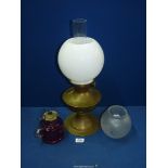 A brass Oil lamp (working) with milk glass globe shade, 19 1/2" tall,