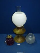 A brass Oil lamp (working) with milk glass globe shade, 19 1/2" tall,