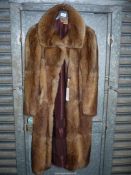 A ladies fur coat by Barkers of Kensignton, size 14 -16.