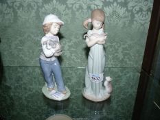 A Lladro figure of a girl with kittens and a Nao figure of a boy holding a dog.