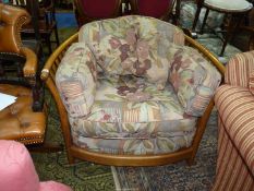 An Ercol slatted sided and backed easy Chair having dark beige ground stylised floral decorated
