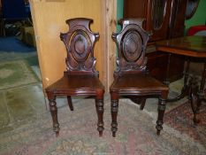 A good pair of circa 1900 Mahogany solid seated Hall Chairs having shaped seats and back rests with