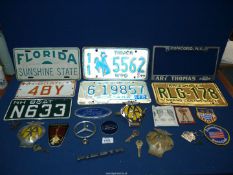 A small quantity of car badges including A.A, Mercedes. Ford etc plus American style number plates.