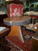 A rustic Oak tree trunk slice topped Occasional Table standing on a triple tree slice base,