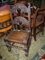 A Lancashire design Oak Hall Chair having arched carved cross-splats,