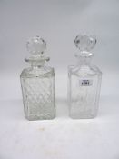 Two square crystal decanters with stoppers, 10 1/4" tall and 10" tall.