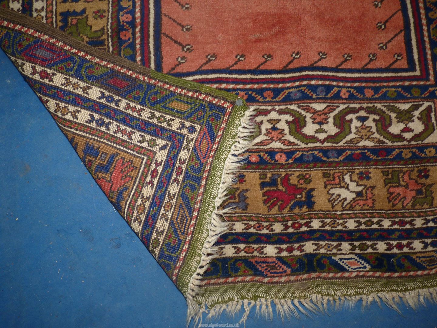 A bordered, patterned and fringed Rug in navy, green and terracotta colours, 72'' x 46''. - Image 2 of 3