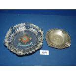 A white metal ashtray with inscription in German translated to 'Offered in gratitude on behalf of