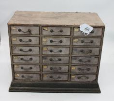 An eighteen drawer unit containing photographic pieces, films, quills,