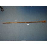 A hazel shaft walking stick with hand carved and painted hare knop having glass eyes,