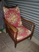 An Oak and other woods semi-reclining 1920/30's Armchair haivng Sanderson style fabric covered