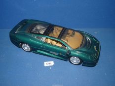 A Maisto 1/12 scale model Jaguar XJ220 in racing green, (rear window cracked).