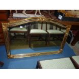 An arched top Overmantel Mirror having unusual narrow mirrored strips to the gilded finished frame,