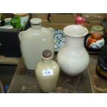 Three stoneware items; hot water bottle, vase and small bottle with lid.