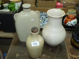 Three stoneware items; hot water bottle, vase and small bottle with lid.