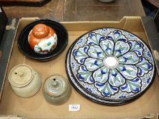 Two chargers in Moorish style decoration of blue, black and green, two Studio Pottery honey jars,