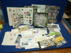 A box of loose stamps, First Day Covers, mint sets , album and sheets.