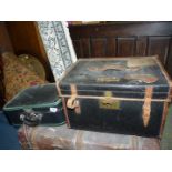 A black leather travel trunk with interior tray with labels to lid,