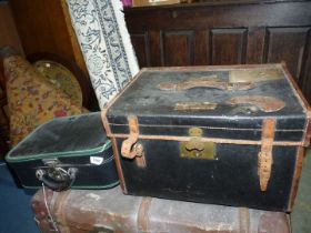 A black leather travel trunk with interior tray with labels to lid,