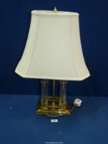 A brass and glass double stem Table Lamp with large cream fabric shade, 25'' high overall.