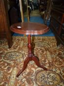 A contemporary dark Mahogany oval topped Wine Table having a turned pillar with three splay feet,