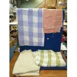 Three woollen blankets; one single in cream, a double in green, orange and cream check,