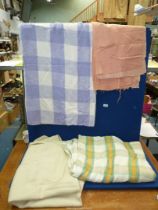 Three woollen blankets; one single in cream, a double in green, orange and cream check,