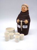 A 1950's Goebel Monk decanter set complete with six glasses, some chips and crazing, 10 1/2'' tall.