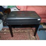 A contemporary black/ebony coloured piano stool,