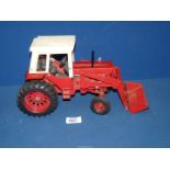 A vintage American ERTL "Farm & Country" model of a red 1/16 scale International 1568 tractor