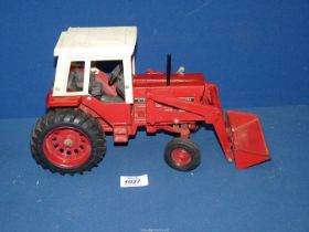 A vintage American ERTL "Farm & Country" model of a red 1/16 scale International 1568 tractor