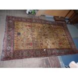 A bordered and patterned Eastern Rug with central panel decorated with a vase of flowers in reds,